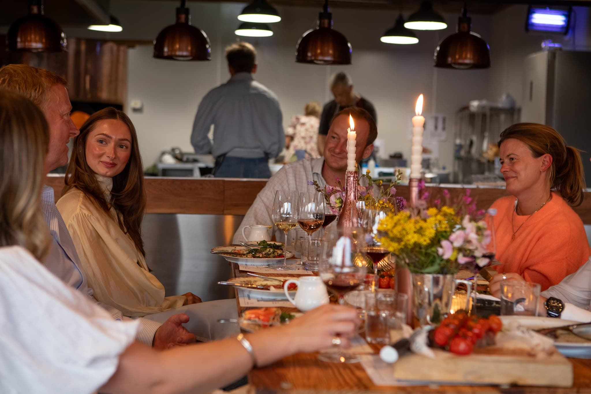 A table of guests by candlelight at The Copse.