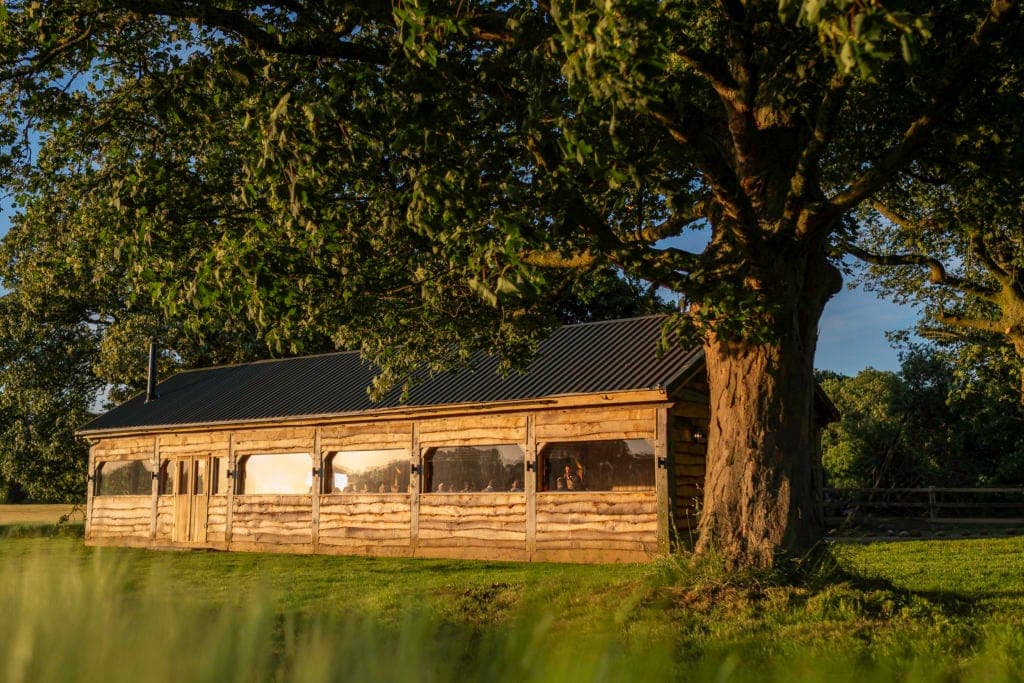 The timber barn at The Copse in golden evening light.